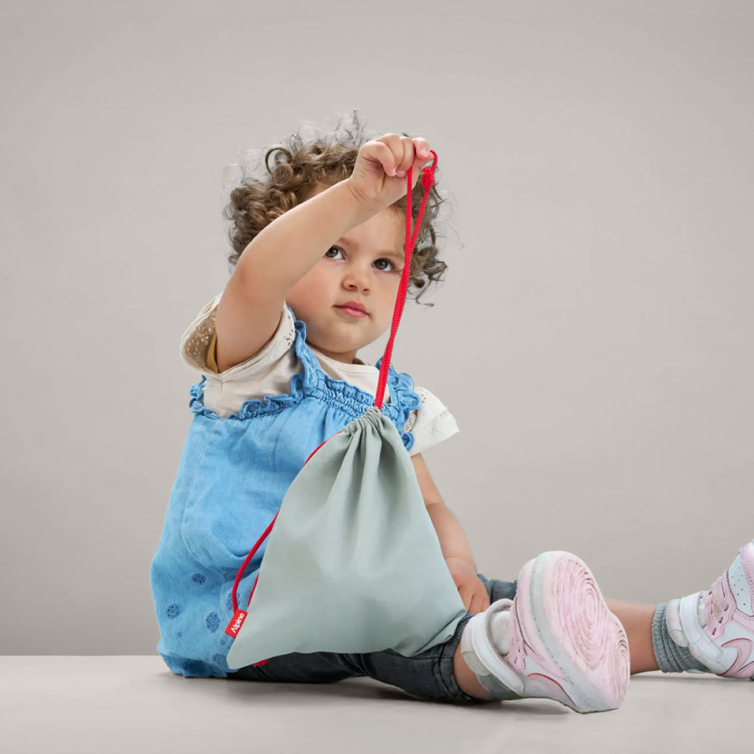 Toddler holding Alpine Muffy Baby storage bag 