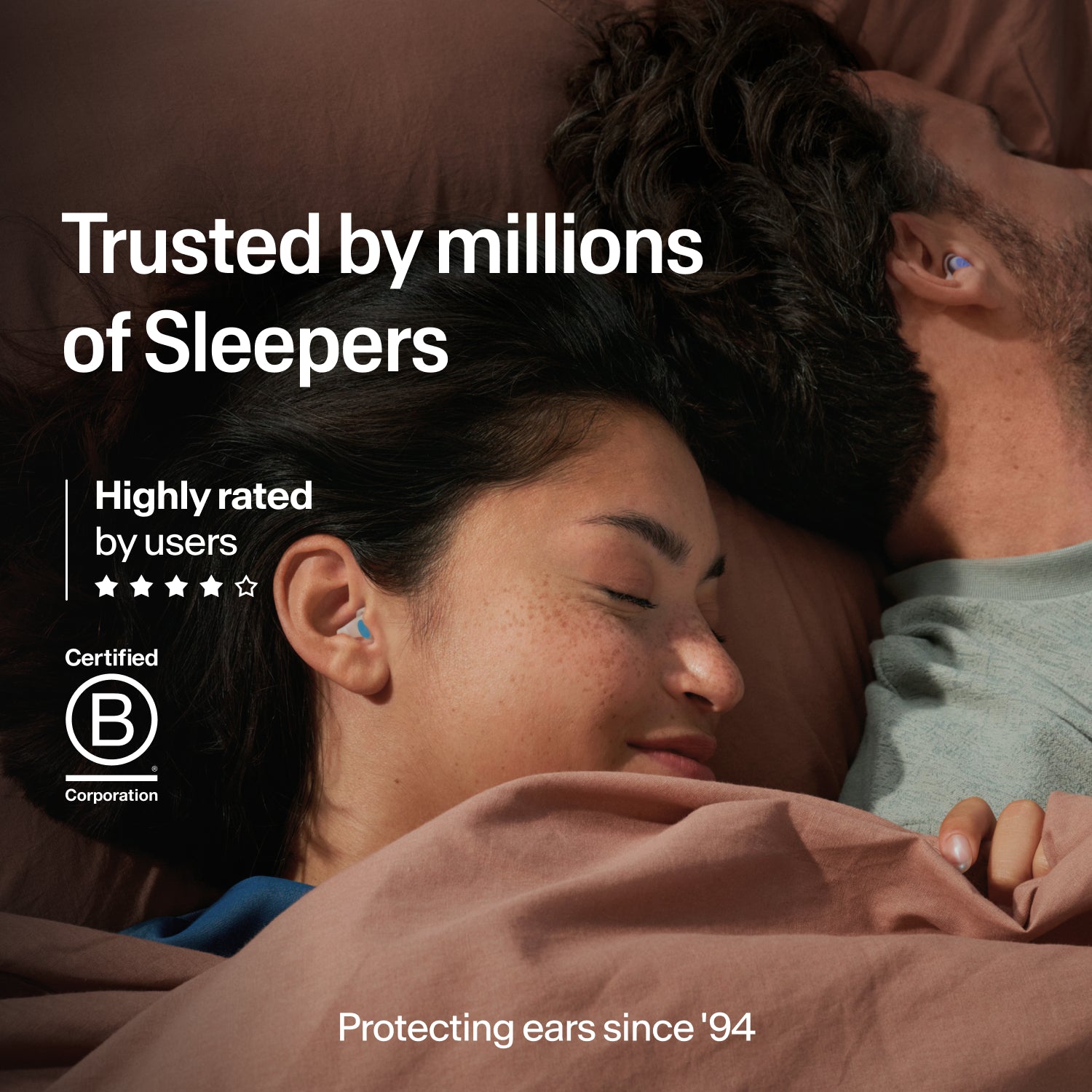 Couple asleep wearing Alpine SleepDeep earplugs in size L, trusted by millions, B Corp certified and protecting ears since 1994 