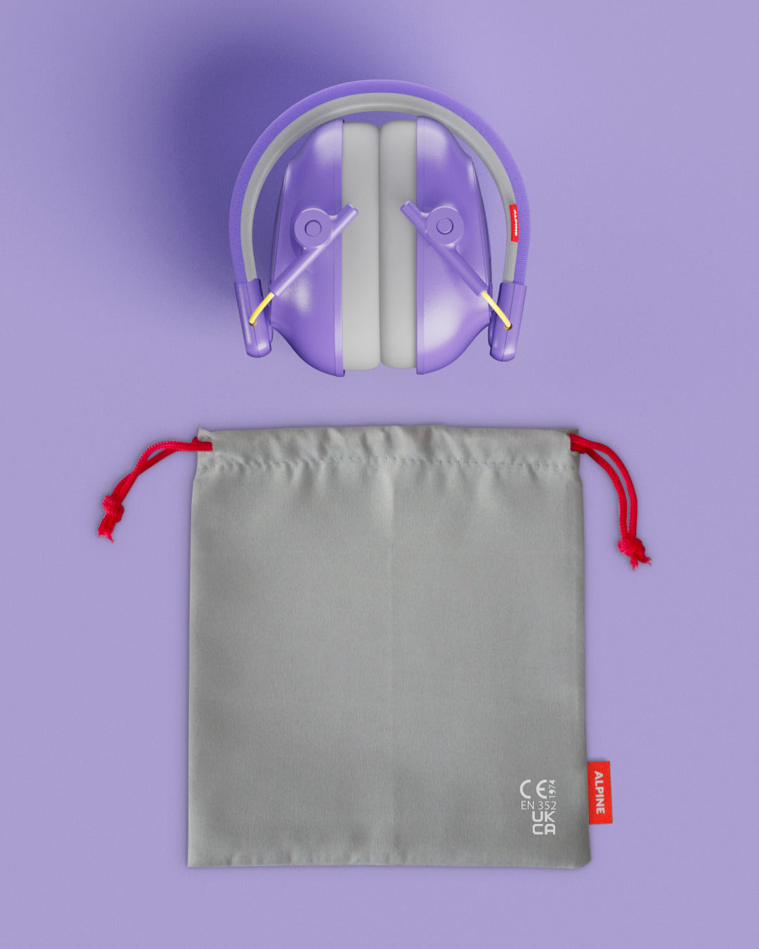 Alpine Muffy Baby ear defenders in purple, folded, with grey carrying pouch 